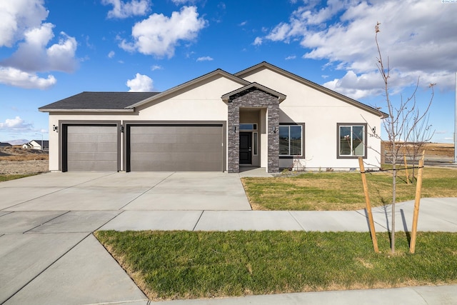 view of front of house with a garage and a front yard