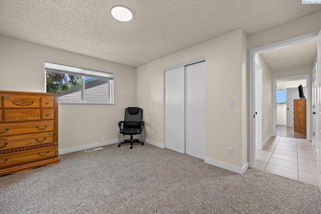 1807 Stevens Dr, Richland, WA 99354 - bedroom featuring carpet floors, a closet, a textured ceiling, and baseboards