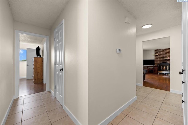 1807 Stevens Dr, Richland, WA 99354 - corridor featuring light tile patterned floors, a textured ceiling, and baseboards