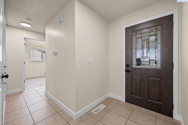 1807 Stevens Dr, Richland, WA 99354 - entrance foyer featuring a textured ceiling, light tile patterned floors, and baseboards