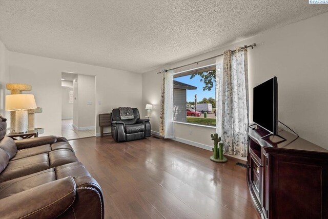 1807 Stevens Dr, Richland, WA 99354 - living room with wood finished floors, a textured ceiling, and baseboards