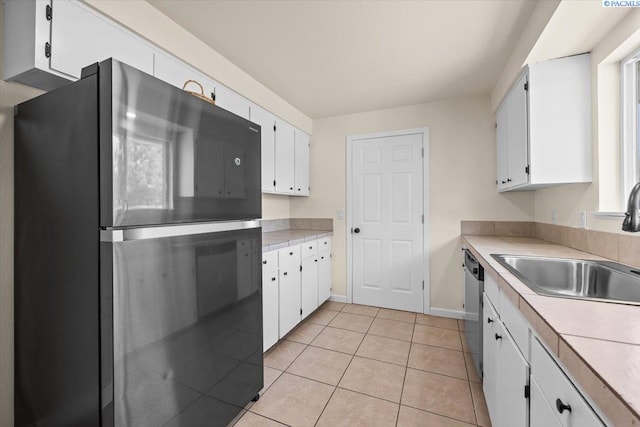 1807 Stevens Dr, Richland, WA 99354 - kitchen featuring freestanding refrigerator, a sink, white cabinetry, light countertops, and light tile patterned floors