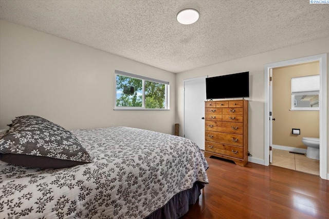 1807 Stevens Dr, Richland, WA 99354 - bedroom featuring wood finished floors, a textured ceiling, and baseboards
