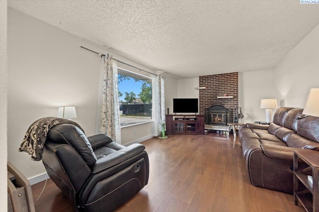 1807 Stevens Dr, Richland, WA 99354 - living area featuring a textured ceiling, wood finished floors, baseboards, and a fireplace