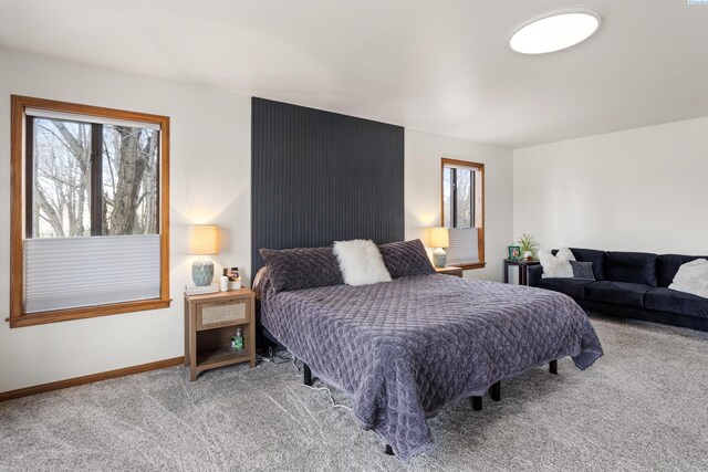 carpeted bedroom with multiple windows and baseboards