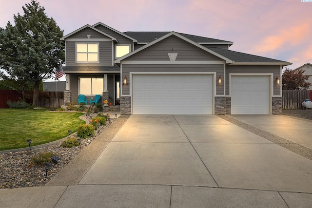 craftsman-style house with a garage, a yard, and covered porch