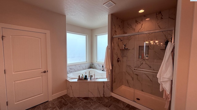 bathroom featuring a textured ceiling, visible vents, marble finish floor, a marble finish shower, and a bath