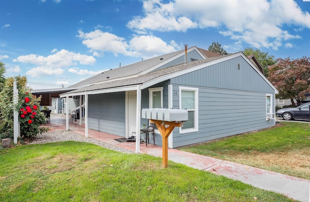 exterior space featuring a lawn and a carport