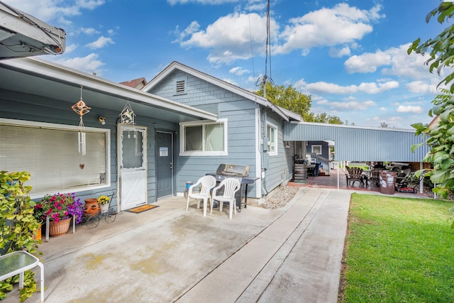 exterior space featuring a patio area and a lawn