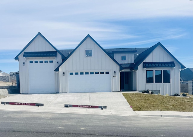 modern farmhouse style home with roof with shingles, board and batten siding, and concrete driveway