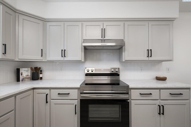 326 Casi Ct, Prosser, WA 99350 - kitchen featuring light stone counters, under cabinet range hood, backsplash, gray cabinets, and stainless steel electric range