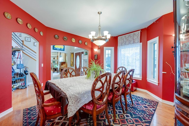 dining space featuring a chandelier and light hardwood / wood-style flooring