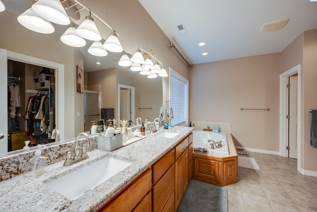 bathroom with plus walk in shower, tile patterned floors, and vanity