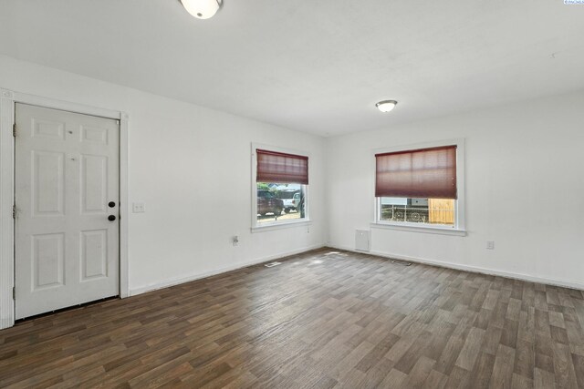 323 S Beech St, Kennewick, WA 99336 - unfurnished living room featuring dark wood-style floors and baseboards