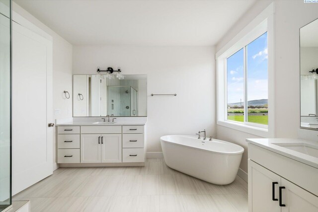 12702 Clark Fork Rd, Pasco, WA 99301 - bathroom featuring a stall shower, two vanities, and a freestanding bath