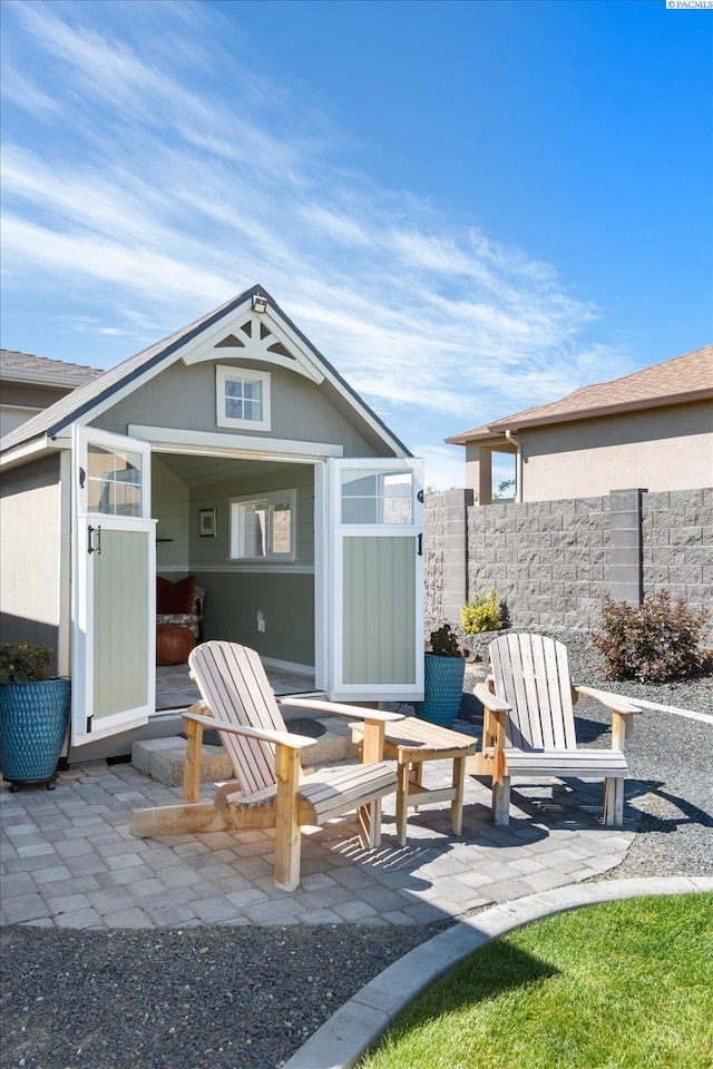 exterior space featuring an outbuilding and a patio area