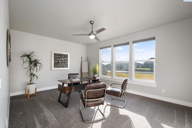 home office with dark carpet and ceiling fan