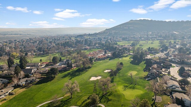bird's eye view with view of golf course, a residential view, and a mountain view