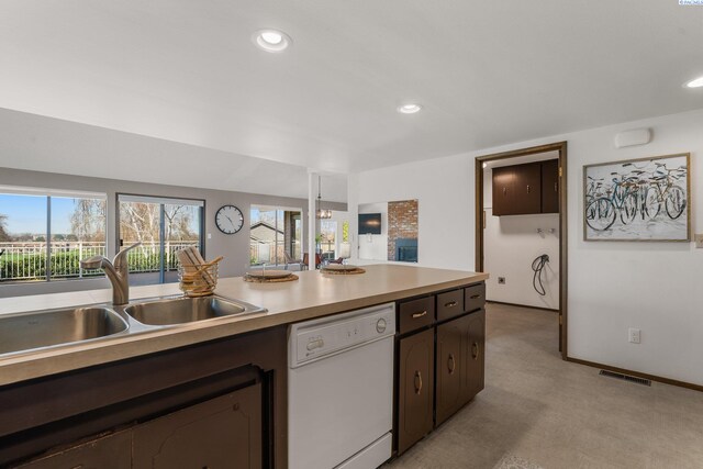 kitchen featuring a sink, visible vents, dark brown cabinetry, dishwasher, and light countertops