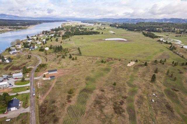 aerial view featuring a water and mountain view