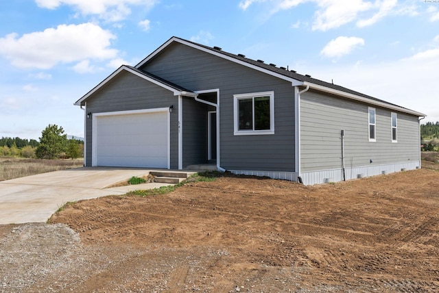 view of front of property with concrete driveway and a garage