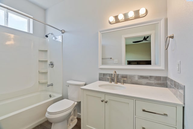 full bathroom featuring vanity, toilet, and  shower combination