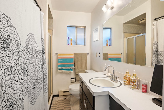 bathroom with walk in shower, vanity, toilet, and a baseboard heating unit