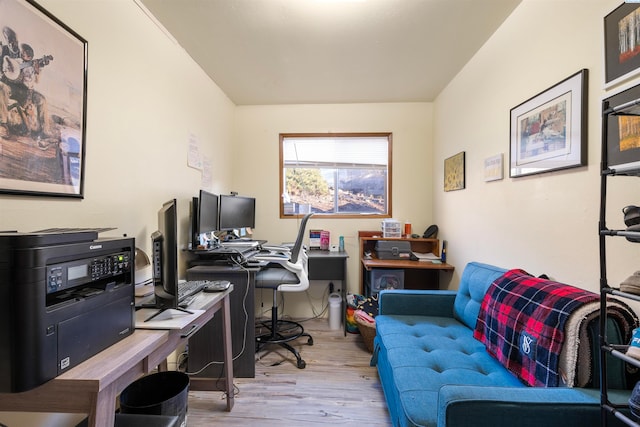 home office with light hardwood / wood-style flooring