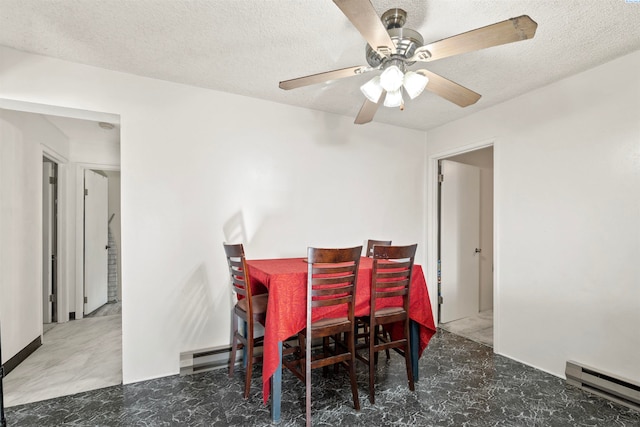 dining space featuring a baseboard radiator, ceiling fan, and a textured ceiling