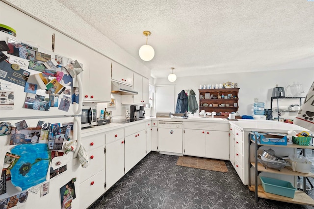 kitchen featuring sink, white cabinets, hanging light fixtures, white appliances, and a textured ceiling