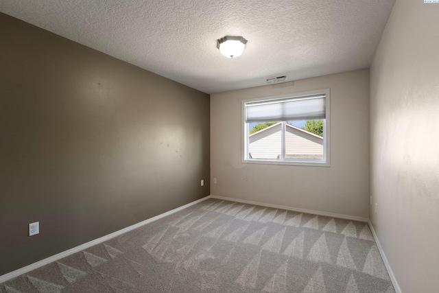 5501 Maui Ct, West Richland, WA 99353 - empty room featuring carpet flooring, a textured ceiling, and baseboards