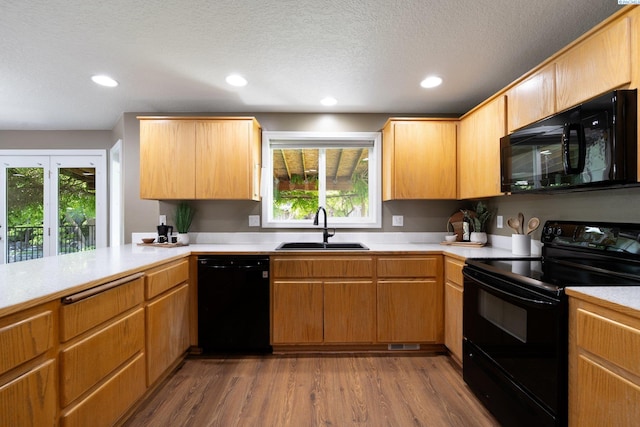 5501 Maui Ct, West Richland, WA 99353 - kitchen with black appliances, a sink, light countertops, dark wood-style flooring, and recessed lighting