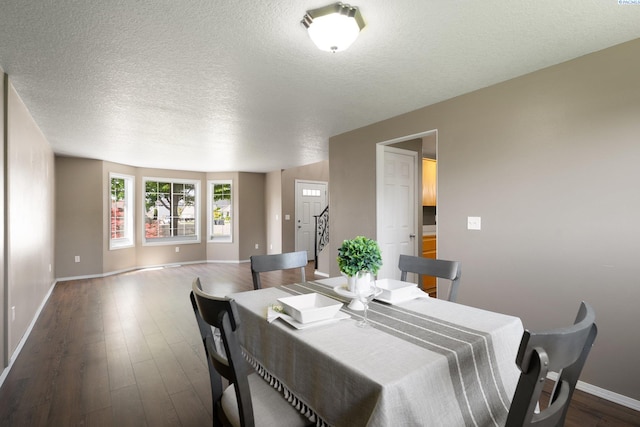 5501 Maui Ct, West Richland, WA 99353 - dining space with baseboards, dark wood finished floors, and a textured ceiling