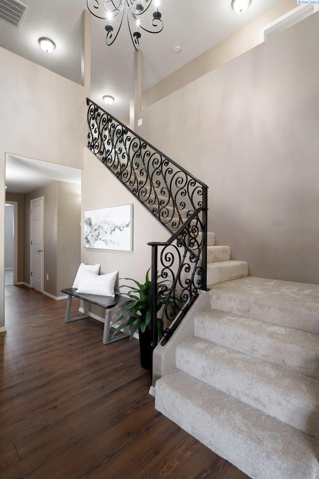 5501 Maui Ct, West Richland, WA 99353 - stairway with wood finished floors, a chandelier, and baseboards