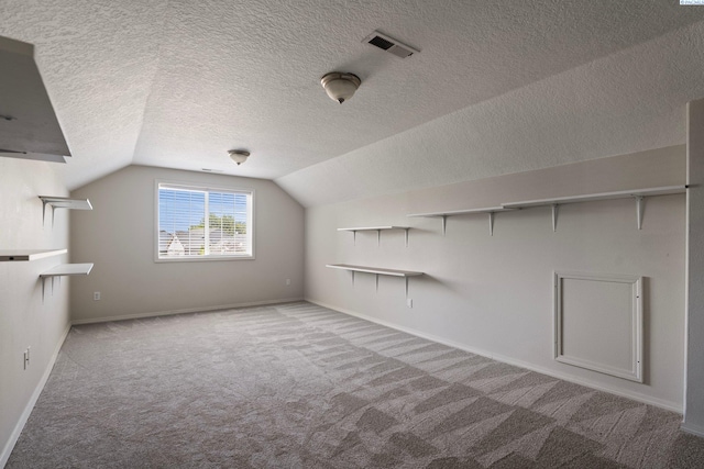 5501 Maui Ct, West Richland, WA 99353 - additional living space featuring carpet floors, vaulted ceiling, baseboards, and a textured ceiling
