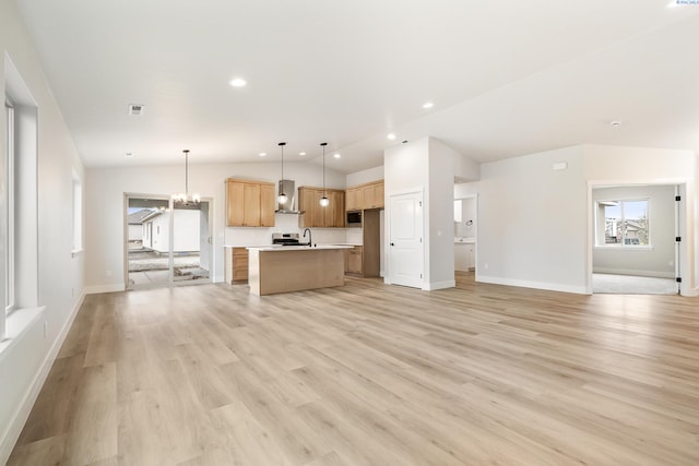 unfurnished living room with an inviting chandelier, sink, vaulted ceiling, and light wood-type flooring