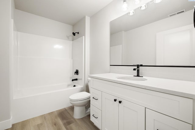 full bathroom featuring vanity, wood-type flooring, tub / shower combination, and toilet