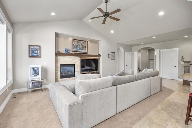 living room with ceiling fan, a fireplace, arched walkways, recessed lighting, and ornate columns