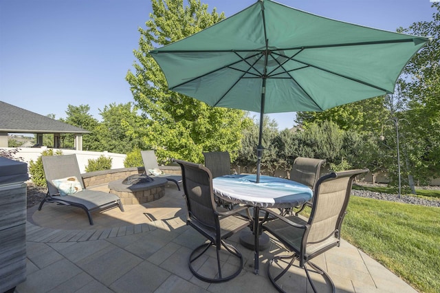 view of patio / terrace featuring outdoor dining space and a fire pit