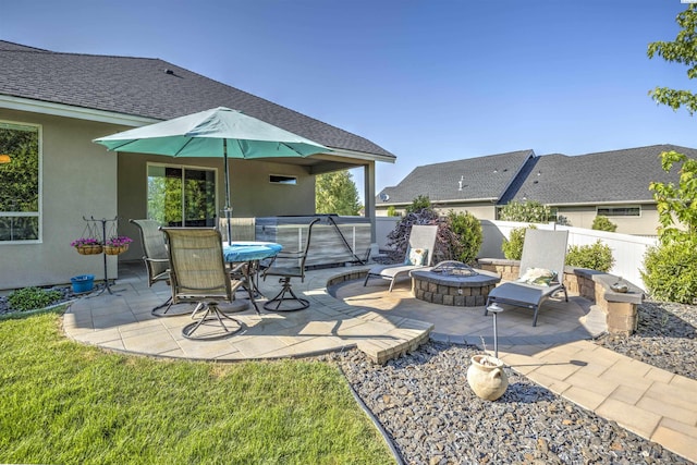 view of patio / terrace with fence and a fire pit