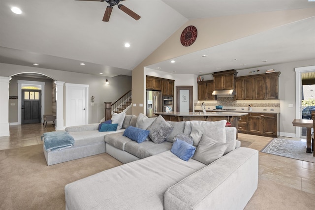 living area featuring a ceiling fan, arched walkways, high vaulted ceiling, ornate columns, and recessed lighting