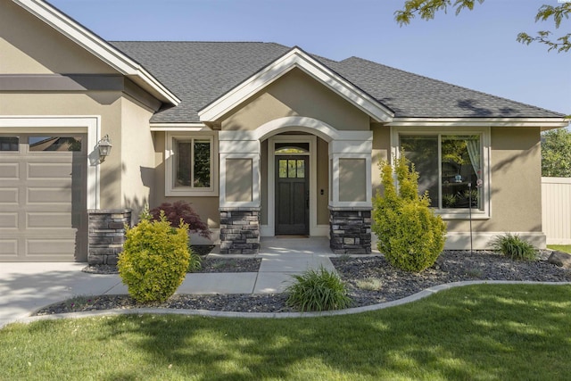 property entrance featuring roof with shingles, stucco siding, an attached garage, and stone siding