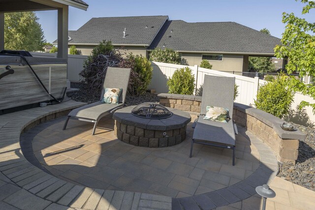 view of patio / terrace with a fenced backyard and a fire pit