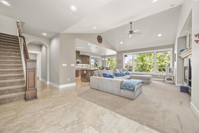 living room featuring baseboards, recessed lighting, ceiling fan, and vaulted ceiling