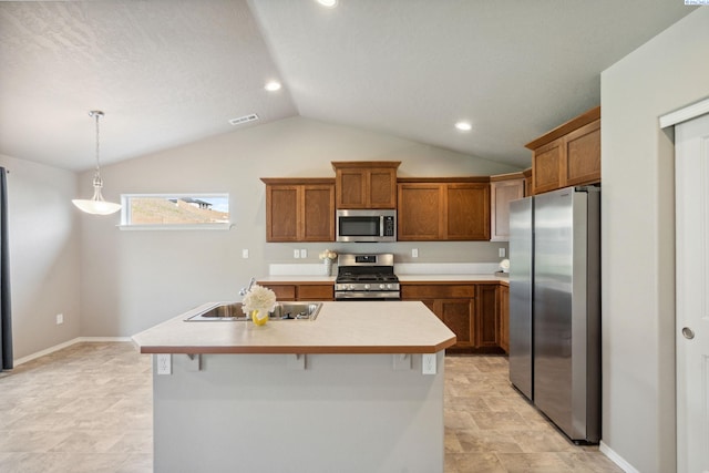 6834 W 25th Ave, Kennewick, WA 99338 - kitchen featuring brown cabinets, appliances with stainless steel finishes, a sink, and vaulted ceiling