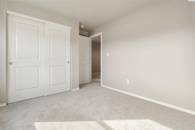 6834 W 25th Ave, Kennewick, WA 99338 - unfurnished bedroom with a closet, baseboards, and light colored carpet