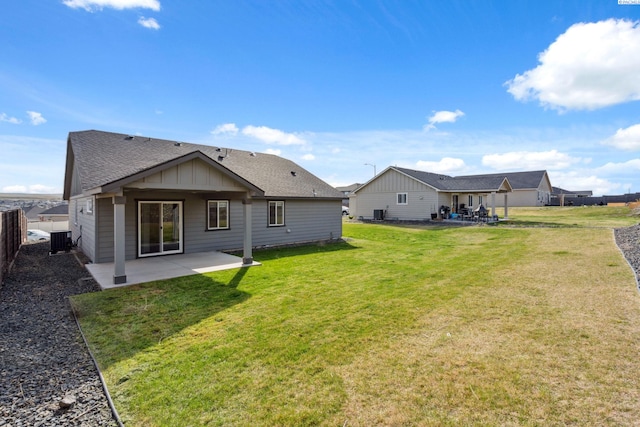 6834 W 25th Ave, Kennewick, WA 99338 - rear view of house featuring a patio, roof with shingles, central air condition unit, and a yard