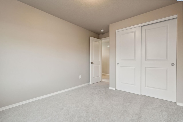 6834 W 25th Ave, Kennewick, WA 99338 - unfurnished bedroom with a closet, carpet flooring, baseboards, and a textured ceiling