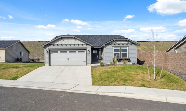 6834 W 25th Ave, Kennewick, WA 99338 - single story home featuring concrete driveway, a front yard, roof with shingles, and an attached garage