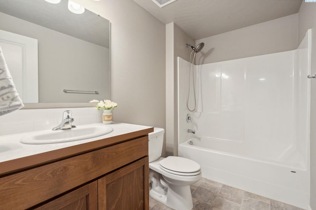 6834 W 25th Ave, Kennewick, WA 99338 - full bath with toilet, bathtub / shower combination, vanity, backsplash, and stone finish flooring